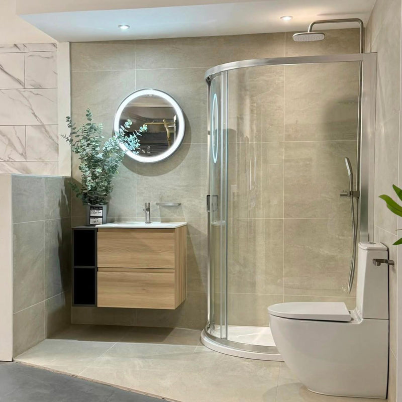 Modern bathroom with shower enclosure, sink, and toilet.